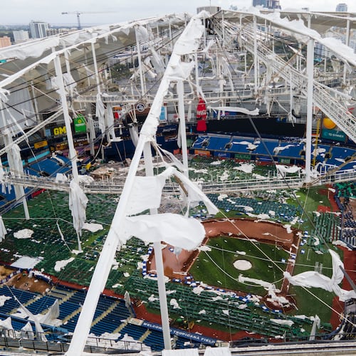 FILE - The roof of the Tropicana Field is damaged the morning after Hurricane Milton hit the region, Oct. 10, 2024, in St. Petersburg, Fla. (AP Photo/Julio Cortez, File)