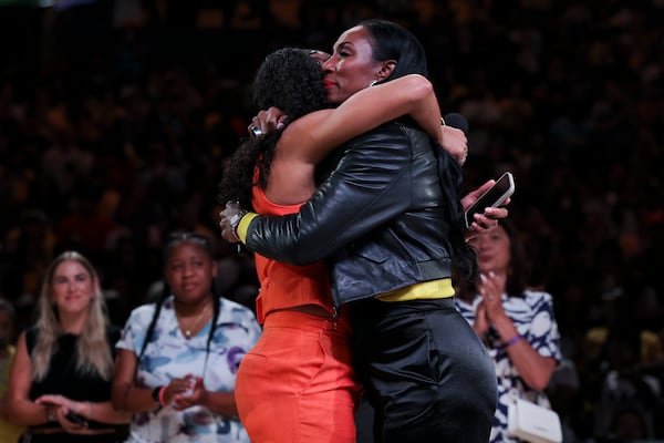 Former Los Angeles Sparks player Candace Parker, left, and former teammate Lisa Leslie, right, embrace during Parker's jersey retirement ceremony during a WNBA basketball game between the Sparks and the Chicago Sky, Sunday, June 29, 2025, in Los Angeles. (AP Photo/Jessie Alcheh)