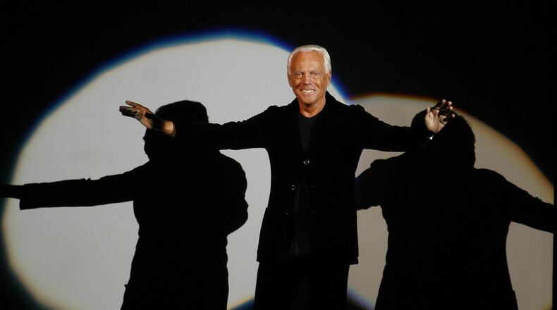 FILE - Giorgio Armani receives his share of applause after presenting his Emporio Fall-Winter 2007-2008 men's fashion collection, during the Milan Men's Fashion Week, in Milan, Italy, Monday, Jan. 15, 2007. (AP Photo/Luca Bruno, File)
