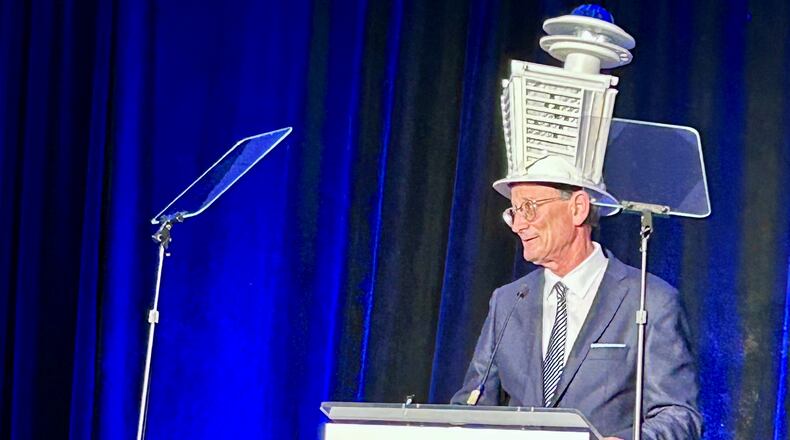 Central Atlanta Progress President and CEO AJ Robinson, wearing a hat that's a replica of the Hyatt Regency Atlanta hotel in downtown, addresses the crowd during the organization's annual meeting Tuesday, Jan. 28, 2025. (J. Scott Trubey/AJC)