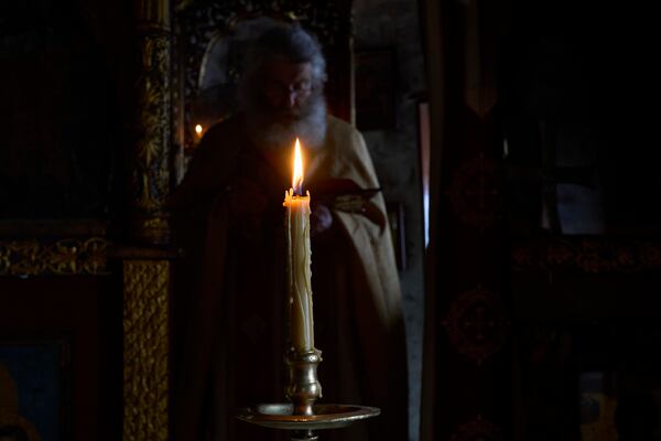 Orthodox Christian monk Father Spyridon conducts the Divine Liturgy in the chapel of the Monastery of Panagia Hozoviotissa in Amorgos island, Greece, on Sunday, March 30, 2025. (AP Photo/Petros Giannakouris)