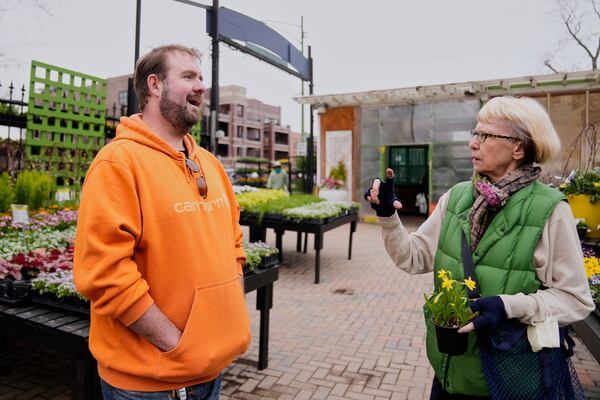 Manager Andrew Balfe, left, helps a customer at Gethsemane Garden Center, Thursday, April 3, 2025, in Chicago. (AP Photo/Erin Hooley)