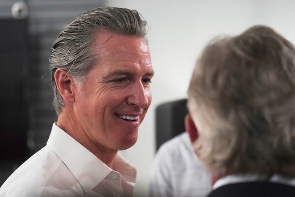 Gov. Gavin Newsom, D-Calif., greets people in a coffee shop during a two-day swing through South Carolina on Tuesday, July 8, 2025, in Florence, S.C. (AP Photo/Meg Kinnard)