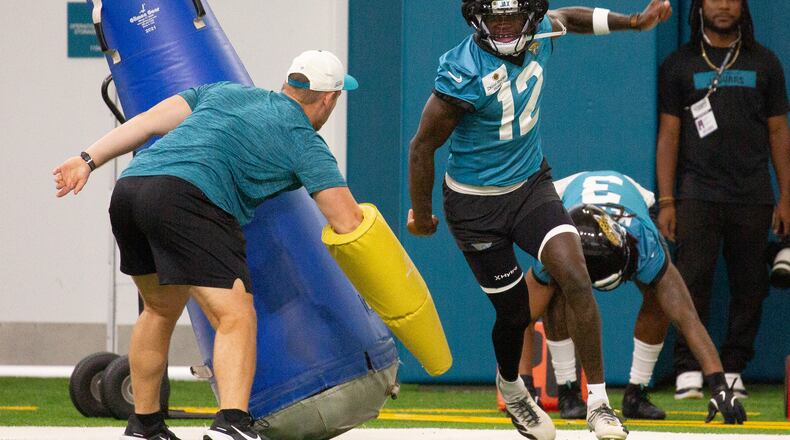 Jacksonville Jaguars wide receiver and cornerback Travis Hunter (12) particpates in drills during practice at the team's NFL football training camp, Thursday, July 30, 2026, in Jacksonville, Fla. (AP Photo/Kelly Jordan)