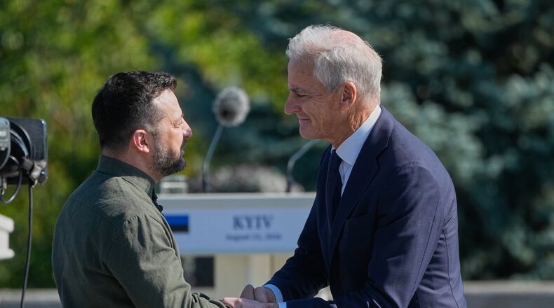 FILE - Ukraine's President Volodymyr Zelenskyy greets Norway's Prime Minister Jonas Gahr Stoere ahead of the flag-raising ceremony to mark the National Flag Day in Kyiv, Ukraine, on Aug. 23, 2026. (AP Photo/Efrem Lukatsky, File)