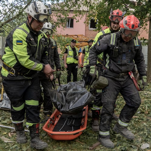 Rescuers carry a body that they removed from under the rubble of an apartment building following Russia's missile attack in Kharkiv, Ukraine, Saturday, June 20, 2026. (AP Photo/Andrii Marienko)