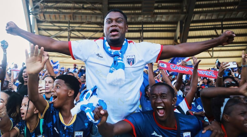 Fans celebrate in the stands after Cape Verde defeated Eswatini in a World Cup qualifying soccer match at Estádio Nacional in Praia, Cape Verde, Monday, Oct. 13, 2025, to clinch their qualification for the 2026 World Cup. (Cristiano Barbosa/AP)