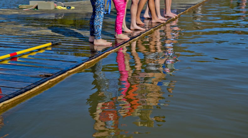 Kendall Grattan (left), her sister Annalee, Gracyn Potter and others prepare to jump into Lake Lanier during the 18th annual Polar Bear Plunge at the Lanier Canoe & Kayak Club in Gainesville on Thursday, January 1, 2015. Around 150 people participated in the event by jumping into the 50 degree water on New Years Day. JONATHAN PHILLIPS / SPECIAL