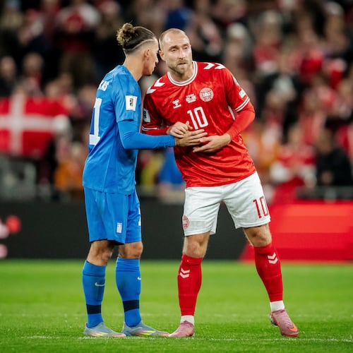 Greece's Kostas Tsimikas, left, and Denmark's Christian Eriksen, right, meet after the World Cup Group C qualification match between Denmark and Greece at Parken stadium in Copenhagen, Sunday, Oct. 12, 2025. (Mads Claus Rasmussen/Ritzau Scanpix via AP)
