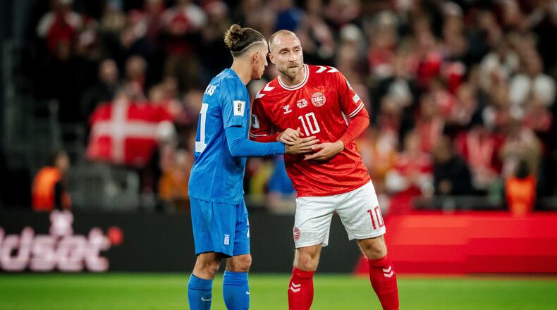 Greece's Kostas Tsimikas, left, and Denmark's Christian Eriksen, right, meet after the World Cup Group C qualification match between Denmark and Greece at Parken stadium in Copenhagen, Sunday, Oct. 12, 2025. (Mads Claus Rasmussen/Ritzau Scanpix via AP)