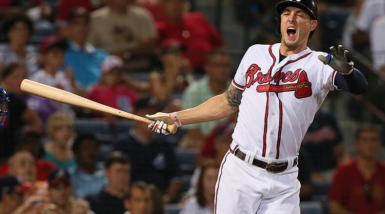 Jordan Schafer turns away from the plate after fouling a pitch off his foot during the 7th inning in Tuesday's game against the Mets at Turner Field. Schafer remained in the game.