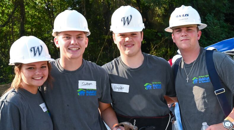 Sutton Cadman, second from left, gathers with other students on Day 1 of the Habitat for Humanity house build in Douglasville. Sutton started a Habitat for Humanity chapter at Alexander High School, and led students in raising funds to build a house for a veteran. Also pictured from left, founding chapter member Mylee Ward, and Sutton's friends, Hayden Arnold and Mason Villa from other schools. Courtesy of Dolly Purvis for Habitat for Humanity of Northwest Metro Atlanta