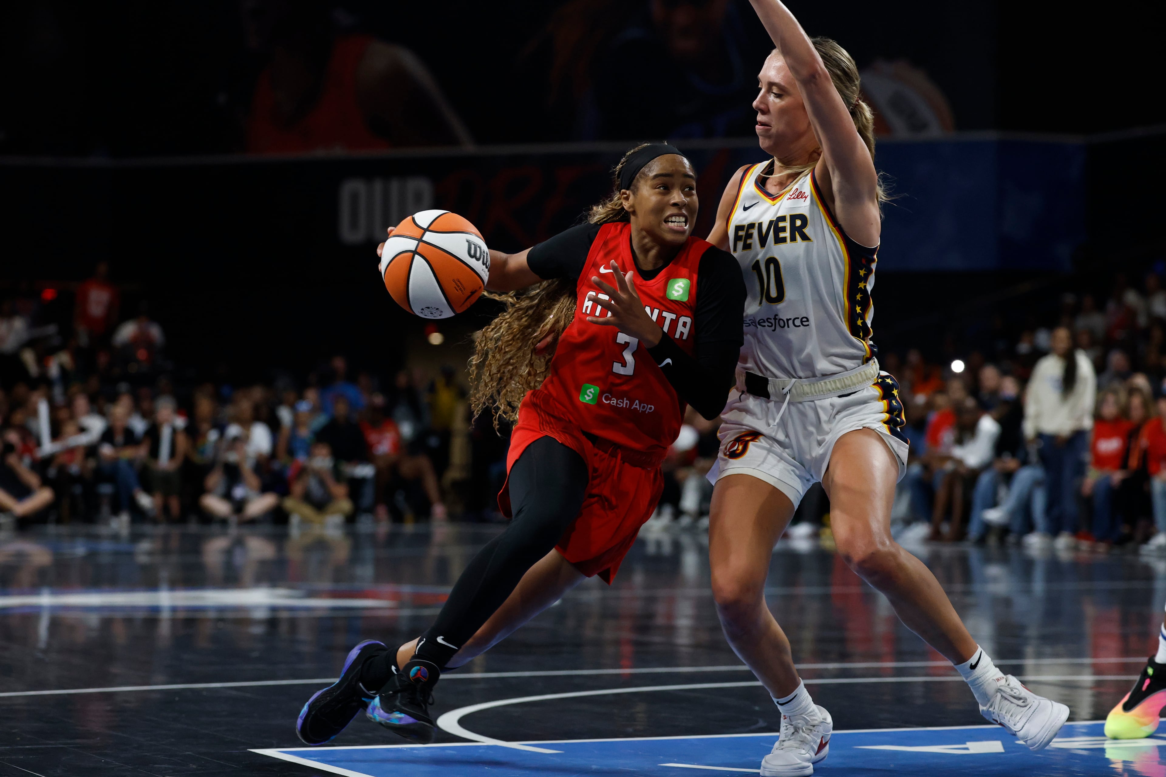 Atlanta Dream guard Jordin Canada (3) drives to the basket around Indiana Fever guard Lexie Hull (10) during the second half of Game 3 in the first round of the WNBA basketball playoffs, Thursday, Sept. 18, 2025, in Atlanta. (AP Photo/Butch Dill)