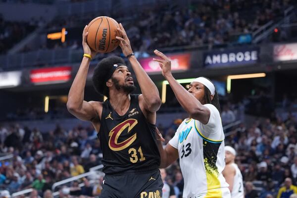 Cleveland Cavaliers center Jarrett Allen (31) shoots over Indiana Pacers center Myles Turner (33) during the first half of an NBA basketball game in Indianapolis, Thursday, April 10, 2025. (AP Photo/Michael Conroy)