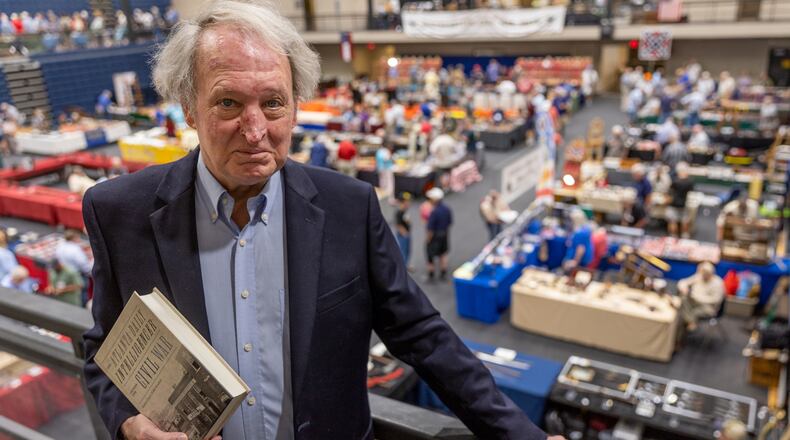 Historian Stephen Davis grew up in Atlanta and attended Margaret Mitchell Elementary School, where a portrait of Vivien Leigh as Scarlett O'Hara stared down at the children in the auditorium. Co-author of "The Atlanta Daily Intelligencer Covers the Civil War," he brought copies of the new book to the recent Civil War Relic Show at the Cobb Civic Center. (Steve Schaefer/steve.schaefer@ajc.com)