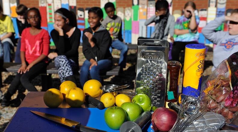 Holeman and Finch chef Linton Hopkins instructs Knight Elementary School students on how to make a citrus vinaigrette dressing for fresh greens. The Captain Planet Foundation, an Atlanta-based organization founded in 1991 by Ted Turner, works with metro Atlanta’s five largest school districts to have learning gardens in all of their schools by 2020. David Tulis/AJC Special