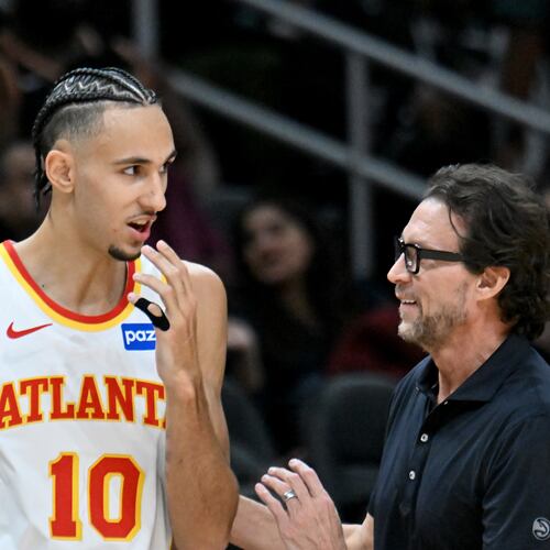 Hawks coach Quin Snyder (right) talks to forward Zaccharie Risacher during the first half Wednesday, Jan. 7, 2026, against the Pelicans at State Farm Arena in Atlanta. Risacher has missed the last eight games since scoring a game-high 25 points on 7-of-9 3-point shooting against New Orleans. (Hyosub Shin/AJC)