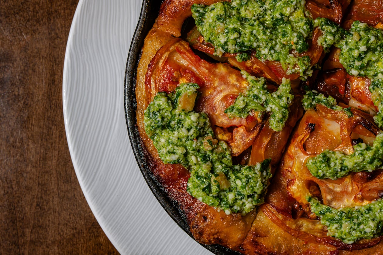 The focaccia barese is part of Scott Conant's latest Americano menu and includes Conant's pugliese focaccia topped with a broccoli rabe pesto and heirloom tomatoes. (Courtesy of Ken Goodman)