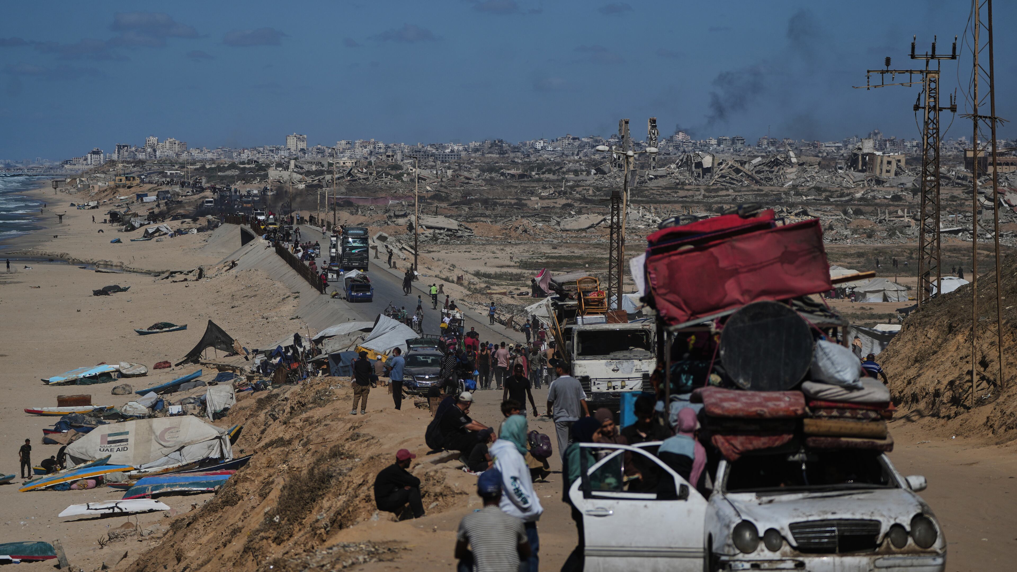 Displaced Palestinians flee northern Gaza carrying their belongings along the coastal road near Wadi Gaza, Wednesday, Oct, 1, 2025. (AP Photo/Abdel Kareem Hana)