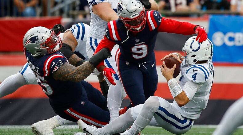 New England Patriots defensive tackle Daniel Ekuale (95) and linebacker Matthew Judon (9) sack Indianapolis Colts quarterback Sam Ehlinger (4) in the first half of an NFL football game, Sunday, Nov. 6, 2022, in Foxborough, Mass. (AP Photo/Michael Dwyer)