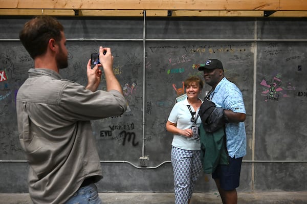 Debbie Miller-Adams (center) and her husband, Larry Adams (right), pose for a photograph during the Trilith Foundation Studio Tour Experience on Thursday, June 11, 2026, in Fayetteville. (Hyosub Shin/AJC)
