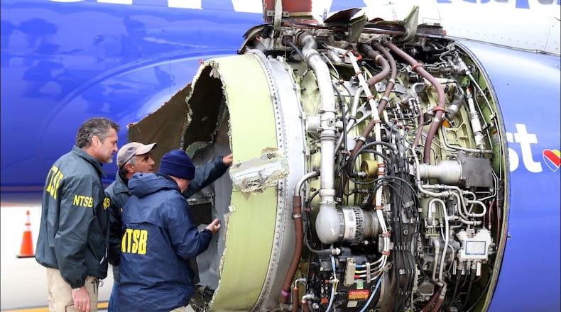 In this National Transportation Safety Board handout, NTSB investigators examine damage to the CFM International 56-7B turbofan engine belonging Southwest Airlines Flight 1380 that separated during flight Tuesday in Philadelphia. Investigators can’t explain with certainty why the left engine in the Boeing 737 malfunctioned but are directing their attention to metal fatigue on fan blades. One woman died during the incident. (Photo by Keith Holloway/National Transportation Safety Board via Getty Images)