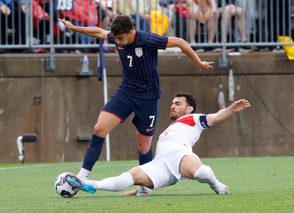 Turkey's Kaan Ayhan slides to kick the ball away from United States midfielder Quinn Sullivan (7) during the second half of an international friendly soccer game, Saturday, June 7, 2025, in East Hartford, Conn. (AP Photo/Mary Schwalm)