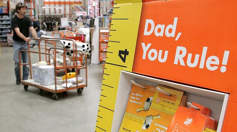 SAN RAFAEL, CA - JUNE 15: A Home Depot customer walks by a display of Father's Day gift cards at a Home Depot store on June 15, 2006 in San Rafael, California. Retail outlets are promoting Father's day gift buying in hopes that the holiday will become more profitable for businesses. (Photo by Justin Sullivan/Getty Images)