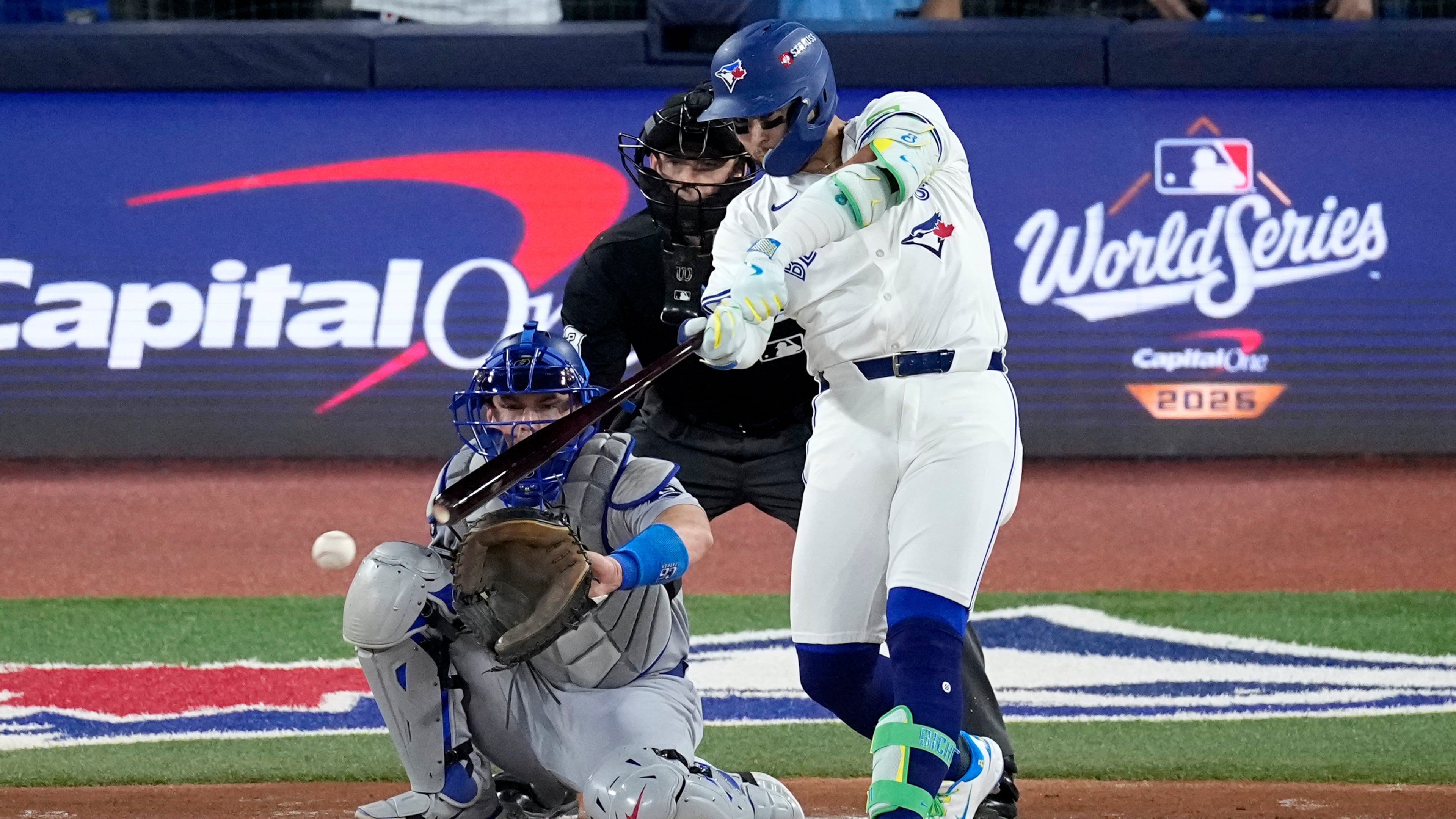 Toronto Blue Jays' Bo Bichette connects for a base hit against the Los Angeles Dodgers during the first inning in Game 1 of baseball's World Series, Friday, Oct. 24, 2025, in Toronto. (AP Photo/David J. Phillip)