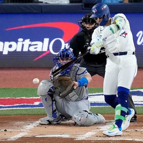Toronto Blue Jays' Bo Bichette connects for a base hit against the Los Angeles Dodgers during the first inning in Game 1 of baseball's World Series, Friday, Oct. 24, 2025, in Toronto. (AP Photo/David J. Phillip)