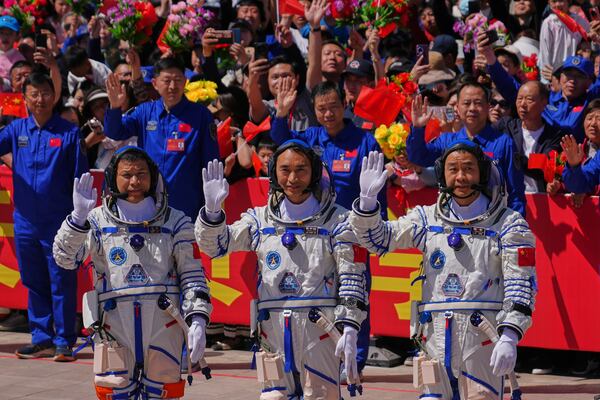 Chinese astronauts for the Shenzhou 20 mission, from right, Chen Zhongrui, Chen Dong and Wang Jie wave as they attend a send-off ceremony for their manned space mission at the Jiuquan Satellite Launch Center in northwestern China, Thursday, April 24, 2025. (AP Photo/Andy Wong)