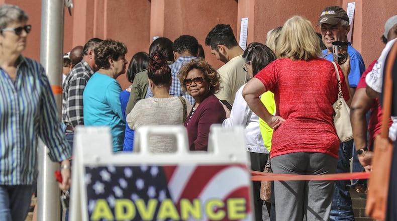 People lined up Thursday at the Cobb County West Park Government Center in Marietta for early voting. The Secretary of State’s Office said nearly 47,000 voter registrations are still pending because they were flagged as not complying with the state’s “exact match” law. JOHN SPINK/JSPINK@AJC.COM