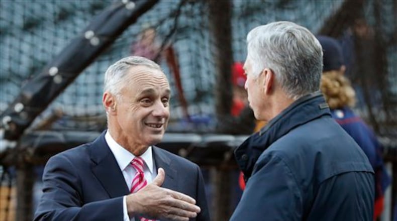 Major League Baseball commissioner Rob Manfred, left, talks with Boston Red Sox president of baseball operations Dave Dombrowski before a baseball game between the Chicago White Sox and the Red Sox Thursday, May 5, 2016, in Chicago. (AP Photo/Charles Rex Arbogast)