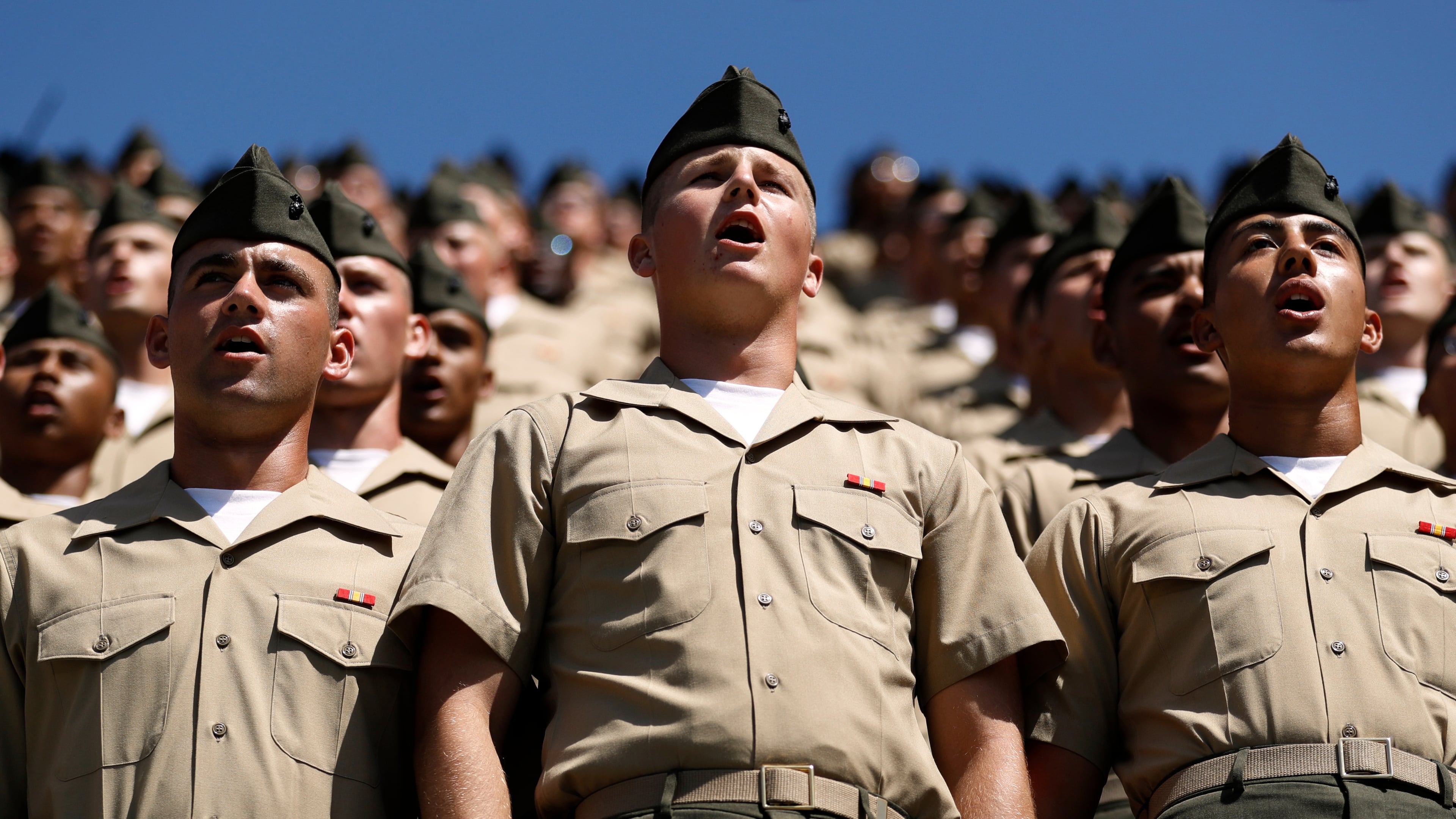 FILE - Recruits from Marine Corps Recruit Depot San Diego sing the Marine's Hymn during a baseball game between the San Diego Padres and the Colorado Rockies, Sept. 8, 2019, in San Diego. (AP Photo/Gregory Bull, File)