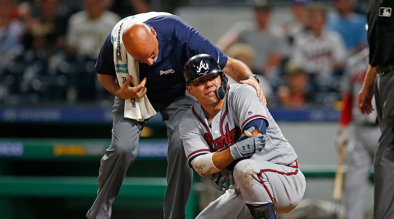 PITTSBURGH, PA - AUGUST 21: Kurt Suzuki #24 of the Atlanta Braves grimaces after being hit by a pitch in the ninth inning against the Pittsburgh Pirates at PNC Park on August 21, 2018 in Pittsburgh, Pennsylvania. (Photo by Justin K. Aller/Getty Images)