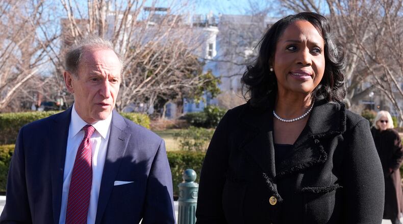 Federal Reserve governor Lisa Cook and attorney Abbe Lowell leave the Supreme Court in Washington, Wednesday, Jan. 21, 2026. (AP Photo/Mark Schiefelbein)