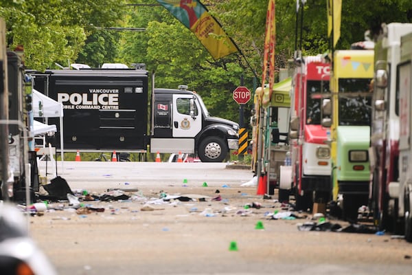 Evidence markers and Vancouver Police vehicles sit at a scene after a driver killed multiple people Saturday during a Filipino community festival Sunday, April 27, 2025, in Vancouver, British Columbia. (AP Photo/Lindsey Wasson)