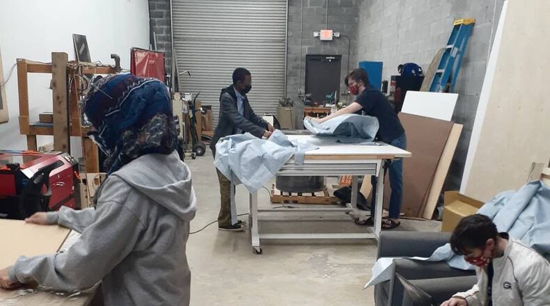 Sprayberry High School students sealing gowns cut by Aylus East Cobb as part of Georgia Makes PPE’s initiatives.