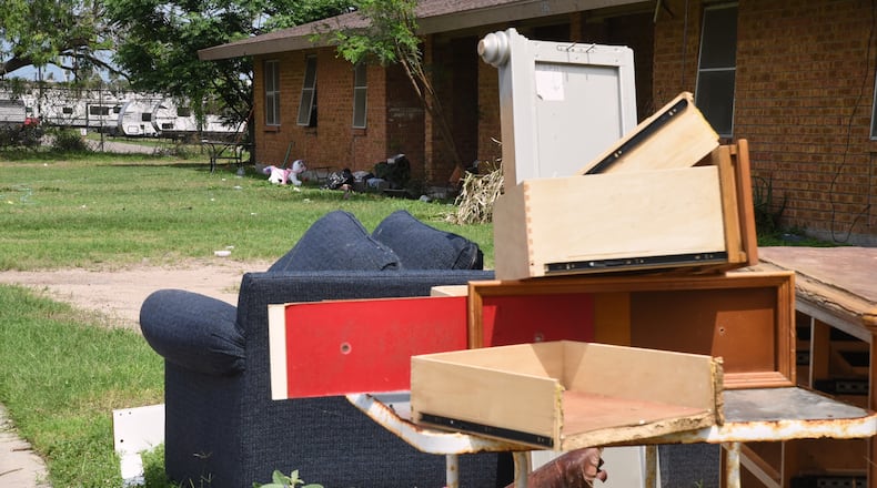 A pile of furniture is piled in a public housing subdivision in Port Isabel, Texas, on April 13, 2026. (AP Photo/Valerie Gonzalez)