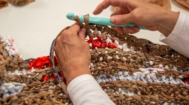 Bags2Blankets founder Janis Sims weaves a ball of plastic bags into blankets at Tucker United Methodist Church. Sims started the project to help the homeless in her community. Tucker Police and a local food bank are handing out the mats. PHIL SKINNER FOR THE ATLANTA JOURNAL-CONSTITUTION.