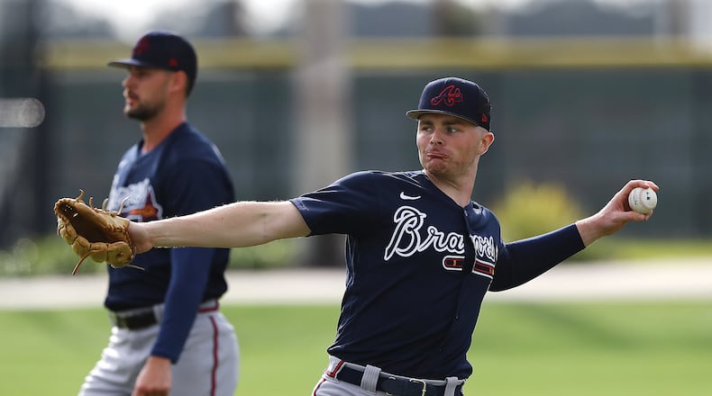 031622 North Port: Atlanta Braves pitchers Sean Newcomb (right) and Kyle Muller loosen up their arms during Spring Training at CoolToday Park on Wednesday, March 16, 2022, in North Port.    “Curtis Compton / Curtis.Compton@ajc.com”