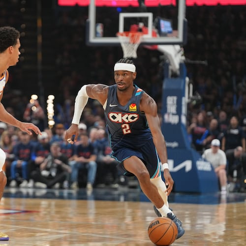 Oklahoma City Thunder guard Shai Gilgeous-Alexander, right, drives past Phoenix Suns forward Oso Ighodaro during the second half in Game 2 of a first-round NBA playoffs basketball series Wednesday, April 22, 2026, in Oklahoma City. (AP Photo/Kyle Phillips)