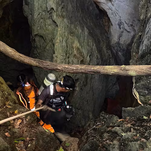 In this image released by Metta Tham Rescue Kalasin, rescuers try to reach people who have been trapped in a cave in Xaisomboun province, Laos, Tuesday, May 26, 2026. (Metta Tham Rescue Kalasin via AP)