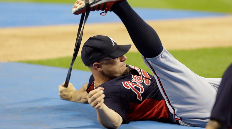 Atlanta Braves right fielder Reed Johnson stretches before a baseball game against the Miami Marlins, Wednesday, Sept. 11, 2013, in Miami.