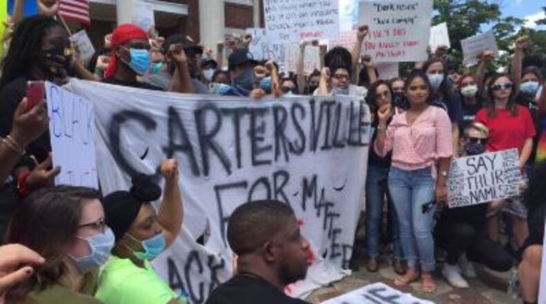 Protesters gather outside the courthouse in Cartersville on Saturday afternoon for a rally denouncing police brutality and championing unity.