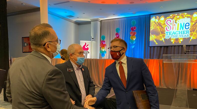 Lee Allen, an algebra teacher at Archer High School in Lawrenceville, greets attendees of Gwinnett County Public Schools' teacher of the year ceremony at the J. Alvin Wilbanks Instructional Support Center in Suwanee. Allen was named the district's top teacher at the ceremony Dec. 7, 2021. Josh Reyes, joshua.reyes@ajc.com.