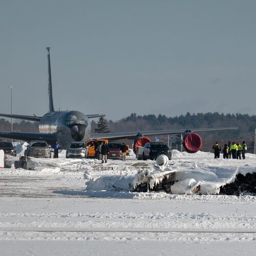Investigators from the Federal Aviation Administration and National Transportation Safety Board investigate a plane crash at Bangor International Airport Wednesday, Jan. 28, 2026 in Bangor, Maine. (Linda Coan O'Kresik/The Bangor Daily News via AP)
