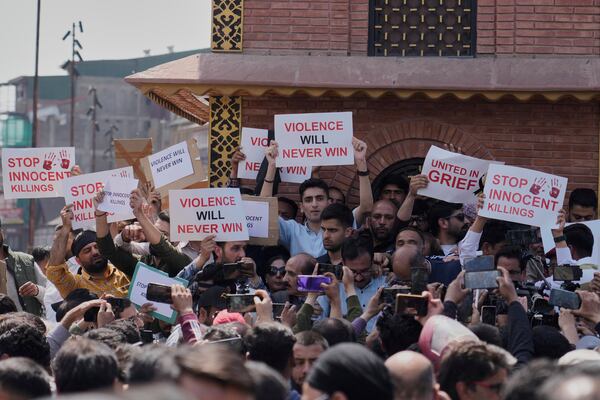 Jammu and Kashmir National Conference (JKNC) members attend a protest after tourists were killed, in Srinagar, Indian controlled Kashmir, Wednesday, April. 23, 2025. (AP Photo/Mukhtar Khan)