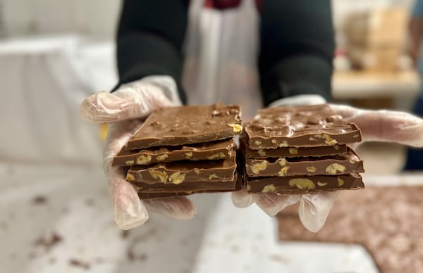 Pecan-chocolate candy is made by hand at Koinonia Farm near Americus. (Joe Kovac Jr./AJC)