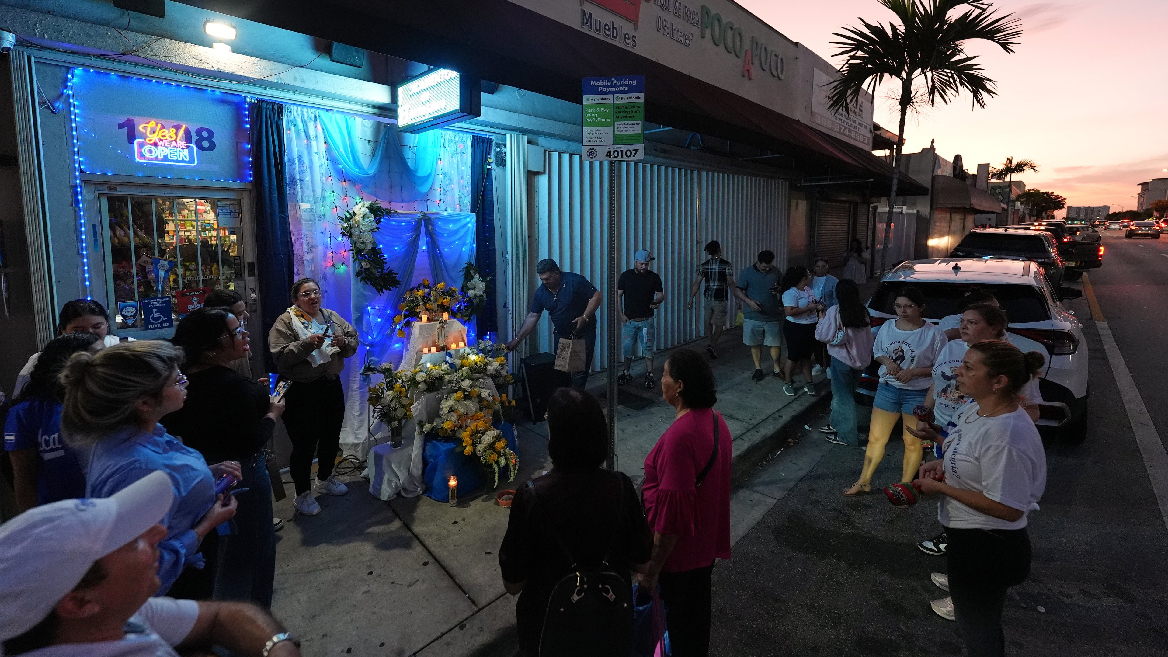 Nicaraguans sing in praise of the Virgin Mary at one of dozens of open-air altars set up near St. John Bosco Catholic Church in celebration of the Dec. 8 feast of the Immaculate Conception, Sunday, Dec. 7, 2025, in Miami. (AP Photo/Rebecca Blackwell)